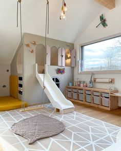 a child's play room with a slide and toys