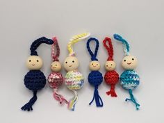 small crocheted toys are lined up on a white surface