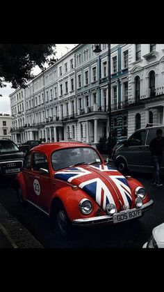 an old red car with the british flag painted on it