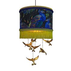 a lamp hanging from the ceiling with birds on it and a blue shade over it