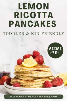 a stack of lemon ricotta pancakes on a plate with strawberries and raspberries