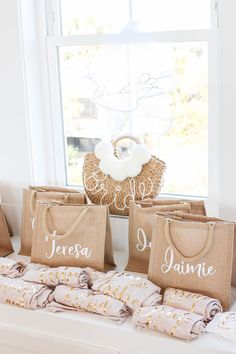 three bags with names on them are sitting in front of a window and some burlocks