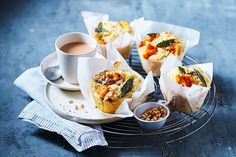 there are several cups and plates with food on the tray next to it, including muffins