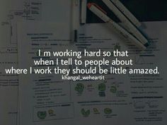 a table with pens and papers on it that says, i'm working hard so that when i tell to people about where i work they should be little