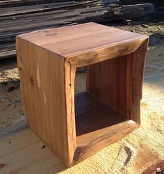 a small wooden box sitting on top of a table next to some wood planks