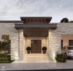 a car is parked in front of a house with stone walls and doors that lead into the driveway