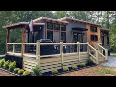 a tiny house in the woods with deck and hot tub