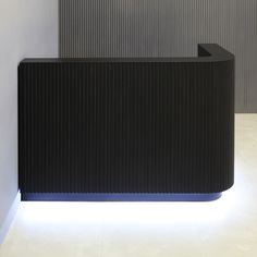 a black and white reception desk with lights