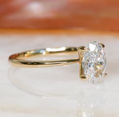 a close up of a diamond ring on a table