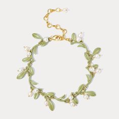 Elevate your elegance with our exquisite Lily of the Valley Bracelet, a piece that exudes the delicate charm and profound symbolism of this beloved bloom. The Lily of the Valley, known for its sweet fragrance and bell-shaped flowers, symbolizes humility, happiness, and renewal. This bracelet not only celebrates the natural beauty of these delicate flowers but also carries their deep symbolic meaning, making it a perfect piece for those who appreciate both elegance and sentiment. Discover the enchanting beauty of nature with our exquisite Lily of the Valley Bracelet, and let it enhance your elegance and style. DETAILS Plating: 18K Gold Materials: 18K Gold on Brass, Freshwater Pearl, Enamel Measurements: Length: 6.69"(17cm) + Extender: 2.76"(7cm) Weight: 12g There will be a little difference Elegant Green Bracelet With Flower Charm, Astrology Jewelry, Lily Of The Valley Flowers, Astrology Necklace, Sweet Fragrance, Moon And Star Ring, Moon And Star Earrings, Zodiac Bracelet, Nature Earrings