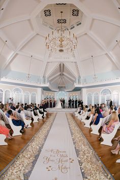 a wedding ceremony is being held in a large room