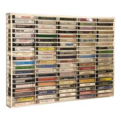 a wall mounted cd rack with many different types of cds on it's sides