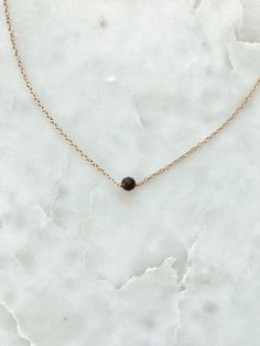 "This is a delicate necklace with black faceted onyx stones secured in the middle of a 14/20 gold-fill, 14/20 rose gold-fill, or Sterling silver chain. You have the option to customize your necklace by selecting either one, two, or three stones to be put on your chain. Pictured: 14\", gold, one bead." Faceted Rose Gold Round Beads Jewelry, Minimalist Onyx Necklace As A Gift, Minimalist Rose Gold Necklaces With Round Beads, Minimalist Rose Gold Round Beads Necklace, Minimalist Gold Crystal Necklace With Faceted Beads, Minimalist Rose Gold Necklace With Round Beads, Dainty Faceted Rose Gold Necklaces, Minimalist Onyx Bead Jewelry, Minimalist Faceted Rose Gold Jewelry