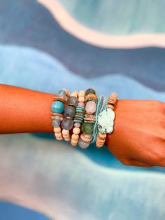 Introducing the Twine & Twig TIDES Collection. From the hues off the coast of Belize to the crystal clear waters of the Bahamas and the impeccable blue-green shades in the seas around Thailand - we cannot help but be drawn to these incredible blue tones. We could watch the range of blue hues come in and out with the tide anywhere in the world and be in complete awe of mother nature's canvas. This eye catching capsule will give you the beachy vibes you've been dreaming of all summer with its use Adjustable Turquoise Beaded Bracelets With Wooden Beads, Bohemian Stretch Bracelet With Large Beads For Everyday, Spiritual Turquoise Beaded Bracelets With Wooden Beads, Spiritual Turquoise Beaded Bracelet With Wooden Beads, Bohemian Turquoise Beaded Bracelets For Everyday, Everyday Bohemian Turquoise Beaded Bracelets, Everyday Bohemian Turquoise Stretch Bracelet, Stackable Heishi Beads Bracelets For Beach, Turquoise Beaded Bracelets With Wooden Beads For Healing