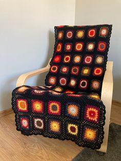 a crocheted chair with a blanket on it