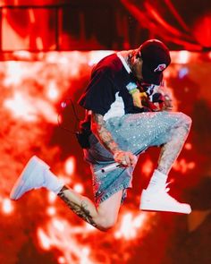 a man jumping in the air on top of a stage