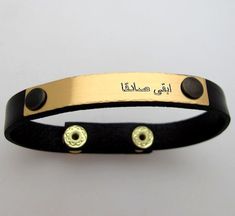 Personalized Arabic Engraved bracelet, Mens bracelets, Custom mens bracelet, Arabic Jewelry - Arabic Name Bracelet - Mens Jewelry Personalized Name Bracelet for men in Arabic language or any other language Hebrew, Chinese, Japanese, French, Spanish etc.. The cuff is made of genuine leather and high quality gold metal details. The focal point of the design is the engraved metal plate. The size of the bracelet is adjustable, so you don't need to worry about the size when order it. Order unique acc Personalized Engraved Black Leather Bracelet, Adjustable Gold Leather Bracelet Engraved, Black Leather Bracelet With Engraving Option, Leather Wristband Gift, Father's Day Adjustable Engraved Leather Bracelet, Father's Day Engraved Adjustable Leather Bracelet, Adjustable Engraved Leather Bracelet, Gold Engraved Leather Bracelet Gift, Classic Leather Bracelet With Engraving Option As A Gift