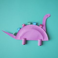 a paper plate shaped like a pink dinosaur