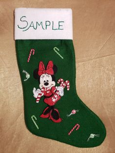 a green christmas stocking with mickey mouse on it