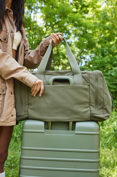 Discover our new utility tote bag in olive green. Perfect for work, travel, or everyday use, shop now for a durable travel tote bag designed to meet all your Casual Cotton Duffle Bag For Overnight Trips, Functional Cotton Bag For Overnight Trips, Large Capacity Cotton Duffle Bag, Cotton Duffle Bag With Large Capacity For Overnight Trips, Cotton Duffle Bag With Luggage Sleeve For Overnight Trips, Cotton Weekender Bag For Overnight Trips, Canvas Travel Bag With Luggage Sleeve For Outdoor Activities, Canvas Travel Bag With Luggage Sleeve For Outdoor, Sporty Travel Bag With Multiple Pockets