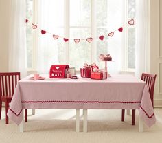 a valentine's day table setting with gifts on it