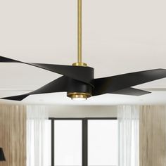 a ceiling fan with black blades hanging from it's side in a living room