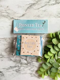 two tea bags sitting on top of a marble counter