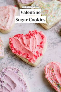 valentine's sugar cookies with pink frosting and sprinkles in the shape of hearts