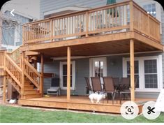 a dog is standing on the front porch of a house with stairs leading up to it