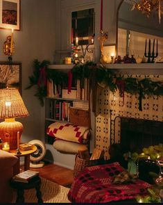 a living room filled with lots of furniture and christmas decorations on top of the fireplace