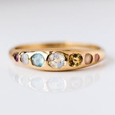 Yowza... The She's an Artist Ring is a serious showstopper. Pink opal, peach moonstone, citrine, opal, aquamarine, chalcedony, amethyst on front with a teeny tiny rainbow moonstone on the back! Love is an understatement, we're obsessed! Pink opal 1.5mm Peach moonstone 2mm Citrine 2.5mm Opal 3mm Aquamarine 2.5mm Chalced Colorful Wedding Ring, Pink Moonstone, Local Eclectic, Wink Wink, Rainbow Sapphires, Moonstone Engagement, Sand Casting, Peach Moonstone, Bridal Bands