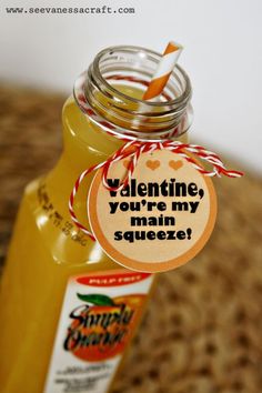 a jar filled with liquid sitting on top of a table next to a sticker that says valentine you're my main squeeze