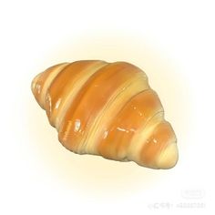 a large croissant sitting on top of a white surface