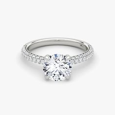 a round brilliant cut diamond ring with pave set shoulders