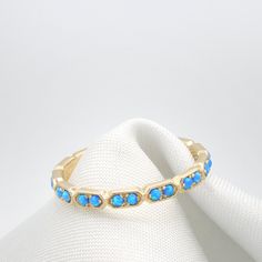 "Opal Eternity Gold ring set with 18 Real Dark Blue opal gem stones. Stunning 18 stone ring with a delicate handmade texture all around the stones. Beautifully Set with Dark Blue Opals and ready to wear alone or as a stacking ring. The back of the ring is Made of a straight line, This allows me to resize the rings quickly and should be inside your palm when you wear this Eternity ring. Lovely Everyday ring with Presence, Elegance and sheer beauty. Perfect for Stacking together with Another ident Handmade Texture, Memory Ring, Gold Eternity Ring, Eternity Ring Gold, Black Stone Ring, Opal Band, Everyday Ring, Gold Ring Sets, Everyday Rings