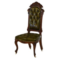 an antique chair with leather upholstered seat