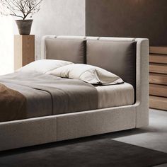 the bed is made up and ready for someone to use it in their home or office