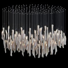 a large chandelier hanging from the ceiling with white glass and metal rods attached to it