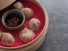 some dumplings are sitting on a red tray