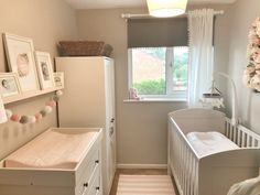 a baby's room with a crib, dresser and bed in the corner