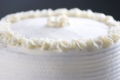 a close up view of a cake with white frosting