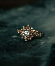 a diamond ring sitting on top of a black surface