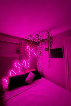 a bed in a room with pink lights on the wall and plants growing over it