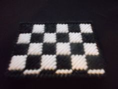 a black and white checkerboard pattern made out of woven material on a table