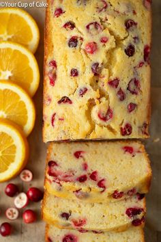 slices of orange cranberry bread next to sliced oranges