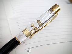 a fountain pen sitting on top of a notebook