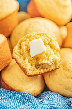 a muffin with a bite out of it sitting on top of a blue towel