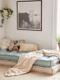 a living room filled with lots of pillows and blankets