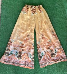 "Vintage sheer floral print palazzo pants. These pants are so fabulous! They almost look like they could have been homemade. They don't have any tags anywhere on them. They fit like an extra small. They feel like a polyester, cotton, and nylon blend. They have an elastic waist. No Pockets. They're in great condition.  Measurements laying flat Across the waist 11\" (22\" total) Elastic waist stretches to about 16\" (32\" total) Top to bottom 37\" Items are shipped out within 1-2 business days. If Bohemian Flare Bottoms For Spring, Full Length Floral Print Wide Leg Pants For Summer, Bohemian Wide Leg Bottoms With Floral Print, Hippie Wide Leg Bottoms With Floral Print, Bohemian Wide Leg Floral Pants For Spring, Bohemian Printed Pants For Spring, Hippie Wide Leg Floral Print Bottoms, Hippie Style Floral Print Wide Leg Pants, Spring Bohemian Wide Leg Full Length Pants