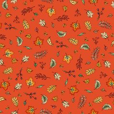 an orange background with lots of leaves and berries on the top of it, all in different colors